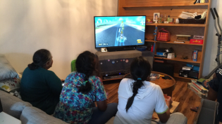 Sharing console gaming with Zoya and Nainamma (his grandma)